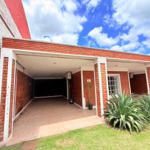 a brick building with a large parking garage at G6 Monoambiente King con Cochera en Villa Ángela in Villa Ángela