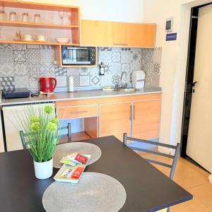 a kitchen with a black table and a kitchen with a microwave at G6 Monoambiente King con Cochera en Villa Ángela in Villa Ángela
