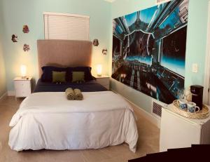 a bedroom with a bed with two shoes on it at Atrium Design District in Miami