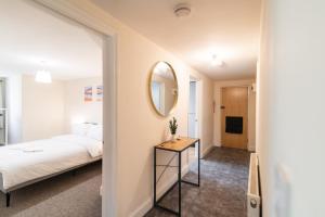 a bedroom with a bed and a mirror at Charming 3 Bed Flat by Harbour in Folkestone