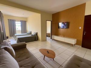 a living room with a couch and a table at Loft Central Orgânico in Passos