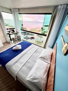 Ένα ή περισσότερα κρεβάτια σε δωμάτιο στο LOFT VISTA MAR - Orla da Praia Grande +24 φωτογραφίες