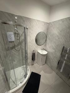 a bathroom with a shower and a sink at Luxury Four Bedroom House in Rock Ferry +31 photos