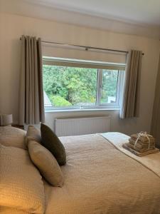 a bedroom with a bed with a large window at Luxury Four Bedroom House in Rock Ferry