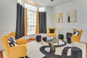 a living room with yellow chairs and a table at Edwards' Palace in Panama City Beach