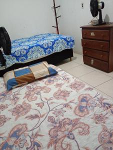 a bedroom with a bed and a dresser at Casa a 5 minutos da Sede da COP30 in Belém