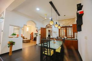 a dining room and kitchen with a table and chairs at SithRu Villa in Matara