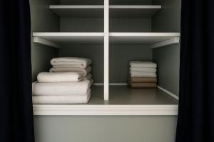 a closet with a bunch of folded towels at Relaxing Stay with Workspace Wifi Lake Views in Mercer +47 photos