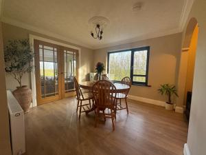 a dining room with a table and chairs at Riversdale Road Tyrone Omagh Fermanagh in Drumquin