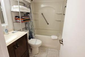a bathroom with a toilet and a sink and a shower at Direct Oceanfront 1BR Balcony King Bed Beach Access in Daytona Beach