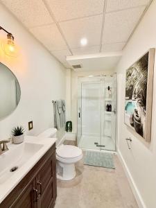 a bathroom with a toilet sink and a shower at Kiari Suites on Main in Moncton +74 photos