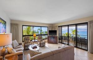 a living room with a couch and a television at Kaanapali Alii 2 Bedroom Oceanfront in Kaanapali