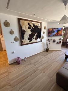 a living room with a couch and paintings on the wall at Casa de Marinero in Martil