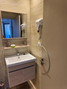 a bathroom with a sink and a mirror at Casa de Marinero in Martil +85 photos