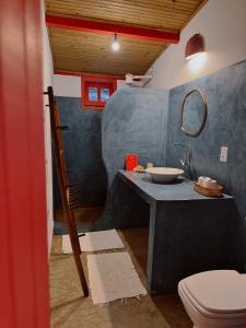 a bathroom with a sink and a toilet at Casa Vulva Caraíva l Hostel feminino com vibe de lar in Caraíva +19 photos