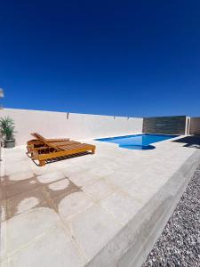 a patio with a swimming pool and a blue sky at Cabañas Batavi in Punta Del Diablo