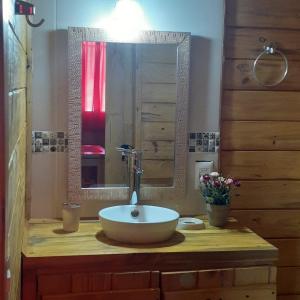 a bathroom with a sink and a mirror at Cabañas Batavi in Punta Del Diablo