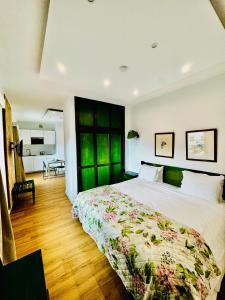 a bedroom with a large bed with a green door at VALE MAR Guest in Ribeira Brava +87 photos