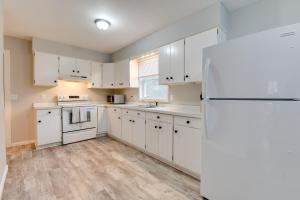 a kitchen with white cabinets and a refrigerator at Ski, Hike and Explore Home 5 Mi to Dtwn Burlington! in Essex Junction