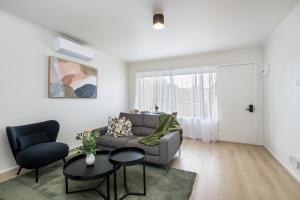 a living room with a couch and two chairs at Newly Renovated Geelong Serviced Apartments by Short & Long Stays in Geelong