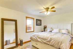 a bedroom with a bed with a ceiling fan and a mirror at 12 Mi to Bozeman Pet-Friendly Gem with Sauna and Yard in Belgrade