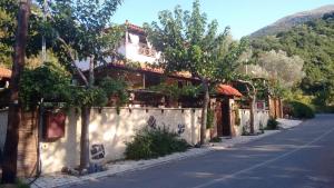 a house on the side of a street at Kalogirou Stone House in Limnionas