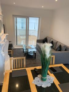 a living room with a couch and a table at Cosy Home Cardiff in Cardiff