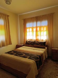 Ένα ή περισσότερα κρεβάτια σε δωμάτιο στο Maison de vaccances Raouia