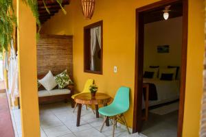 a room with a table and chairs and a bed at Pousada João Maria in Trancoso +25 photos