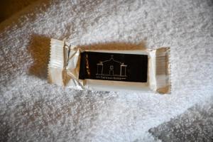 a bottle of soap sitting on top of white paper at Pousada João Maria in Trancoso