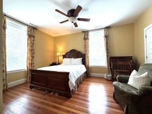 a bedroom with a bed and a ceiling fan at The Grand Lux Inn in Tullahoma