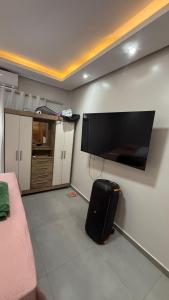 a living room with a flat screen tv on the wall at Casa Pé no Sal in Salinópolis