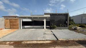 a house with a large parking lot with a garage at Casa Pé no Sal in Salinópolis