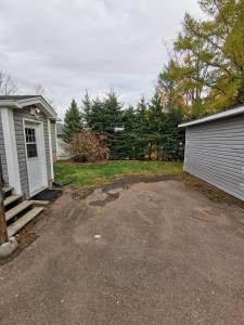 a driveway in front of a house with a garage at Oscar's Retreat - 1Bedroom Apart in Moncton