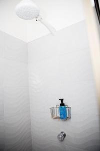 a shower with a soap dispenser on a wall at CASA HOTEL FIBA MAGUEZA in San Francisco