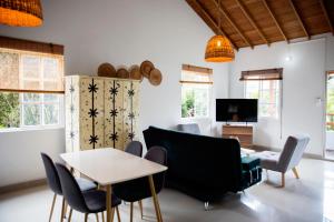 a living room with chairs and a table and a tv at CASA HOTEL FIBA MAGUEZA in San Francisco