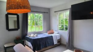 a bedroom with a bed and two windows at CASA HOTEL FIBA MAGUEZA in San Francisco +71 photos