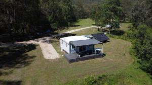 an aerial view of a tiny house with solar panels at The Burrows Off Grid Cabin, Unplug, Relax & Unwind in Wollombi