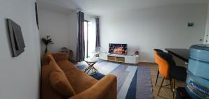 a living room with a couch and a tv at Cozy nest in Tatu City