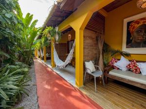a porch of a house with a hammock at Pousada João Maria in Trancoso
