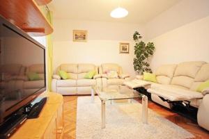 a living room with two couches and a tv at Apartments with parking space Vrboska, Hvar - 24967 in Vrboska