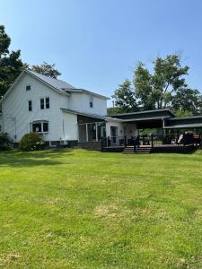 a large white house with a large yard at Welcome to Duck Run in Mackeyville, Pennsylvania! in Mill Hall