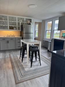 a kitchen with a white table and black chairs at Welcome to Duck Run in Mackeyville, Pennsylvania! in Mill Hall