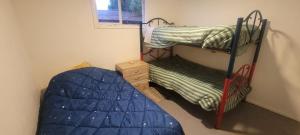 a bedroom with two bunk beds and a bed at Casa Club in Puerto Montt +1 photo