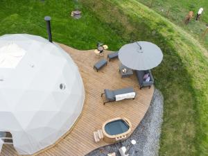 an overhead view of a wooden deck with a white umbrella at Gwenllian in Machynlleth