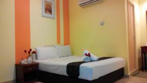 Postel nebo postele na pokoji v ubytování Sun Inns Hotel Puchong
