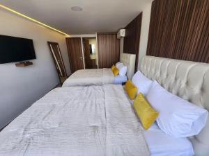 a hotel room with two beds and a flat screen tv at 21 Bella habitación Consulado in Guadalajara