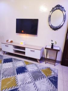 a living room with a flat screen tv on a wall at STUDIO pour les personnes a mobilité réduite in Dakar