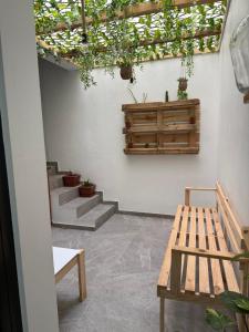 a patio with a bench and stairs with potted plants at Castro AP in Mindelo