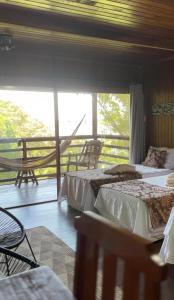 a bedroom with two beds and a balcony at Bela Vista Lodge in Novo Airão
